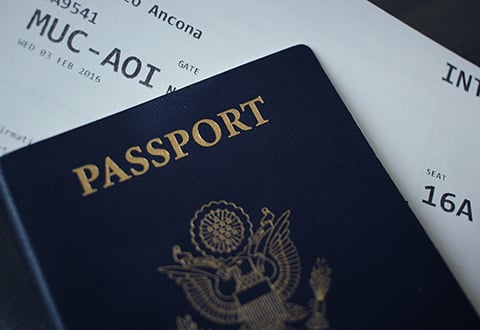 Photo of passport and plane ticket