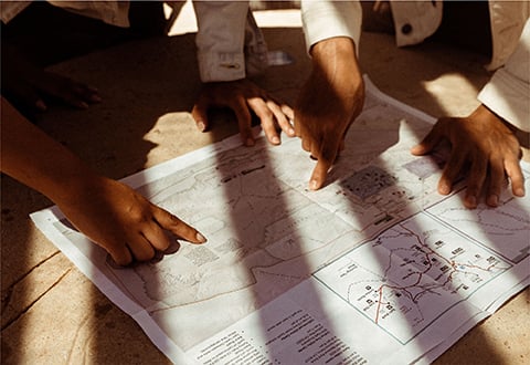 Hands pointing to a map