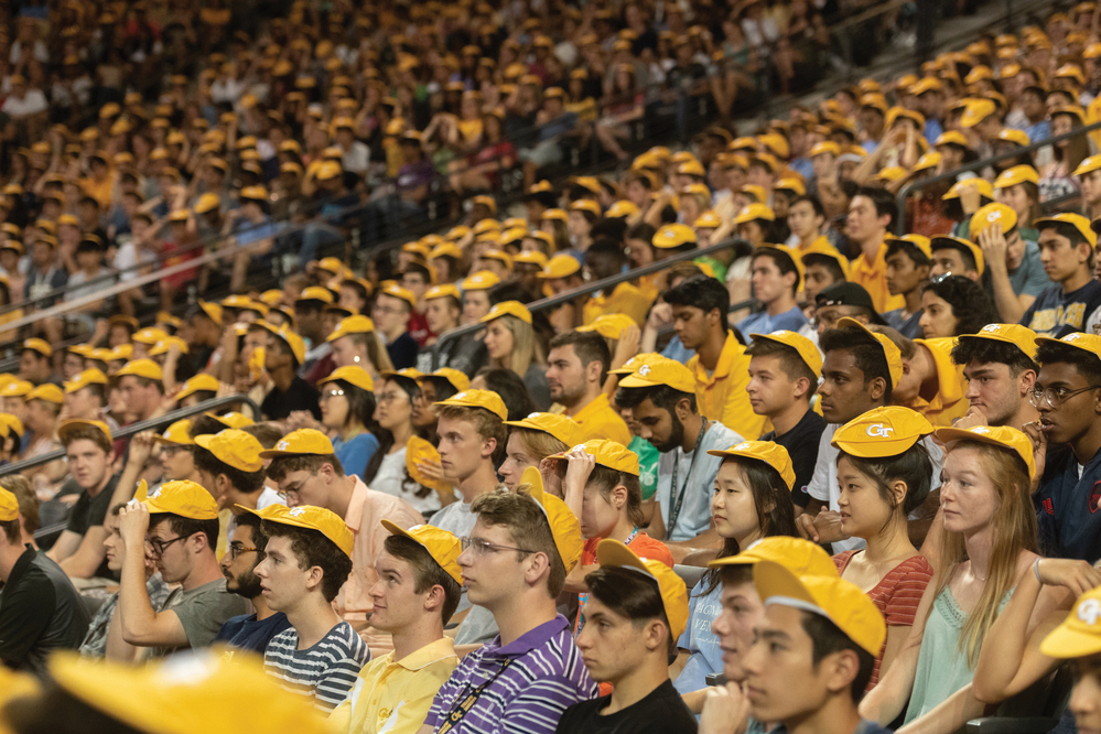 GT students sitting in the bleachers with their rat caps