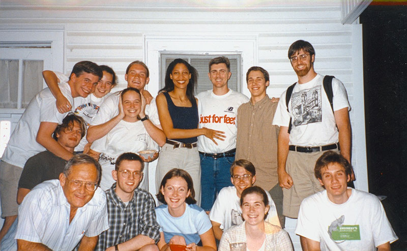 (Top L-R) James Clawson, Phebe Clawson Connors, Jacob Adams, Catie Newell, Tahirah Elliott, Travis Elliott, David Reid, David Connors, (Kneeling) Drake Tolliver, (Bottom L-R) Miller Templeton, Chris Baucom, Anna Fincher Pinder, Justin Crowell, Karen Feigh, Gary Yngve. Pictured on the porch of 469 10th St. in the early ‘90s.