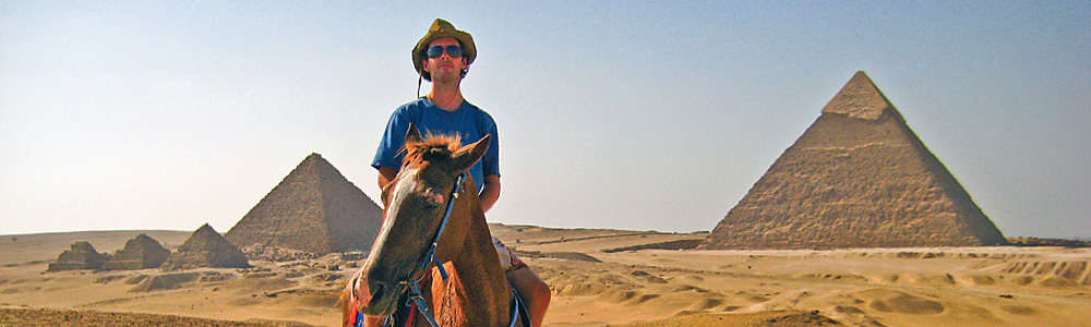 Brandon Cox in the foreground with the Pyramids of Giza behind him