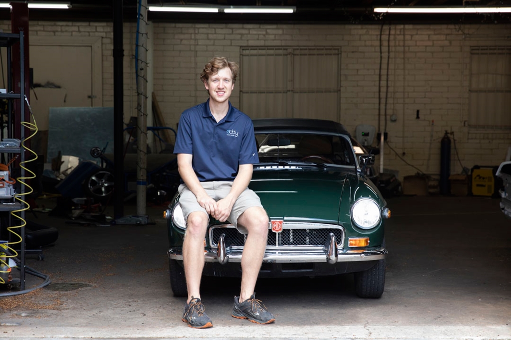Ben Horst sitting on a classic car
