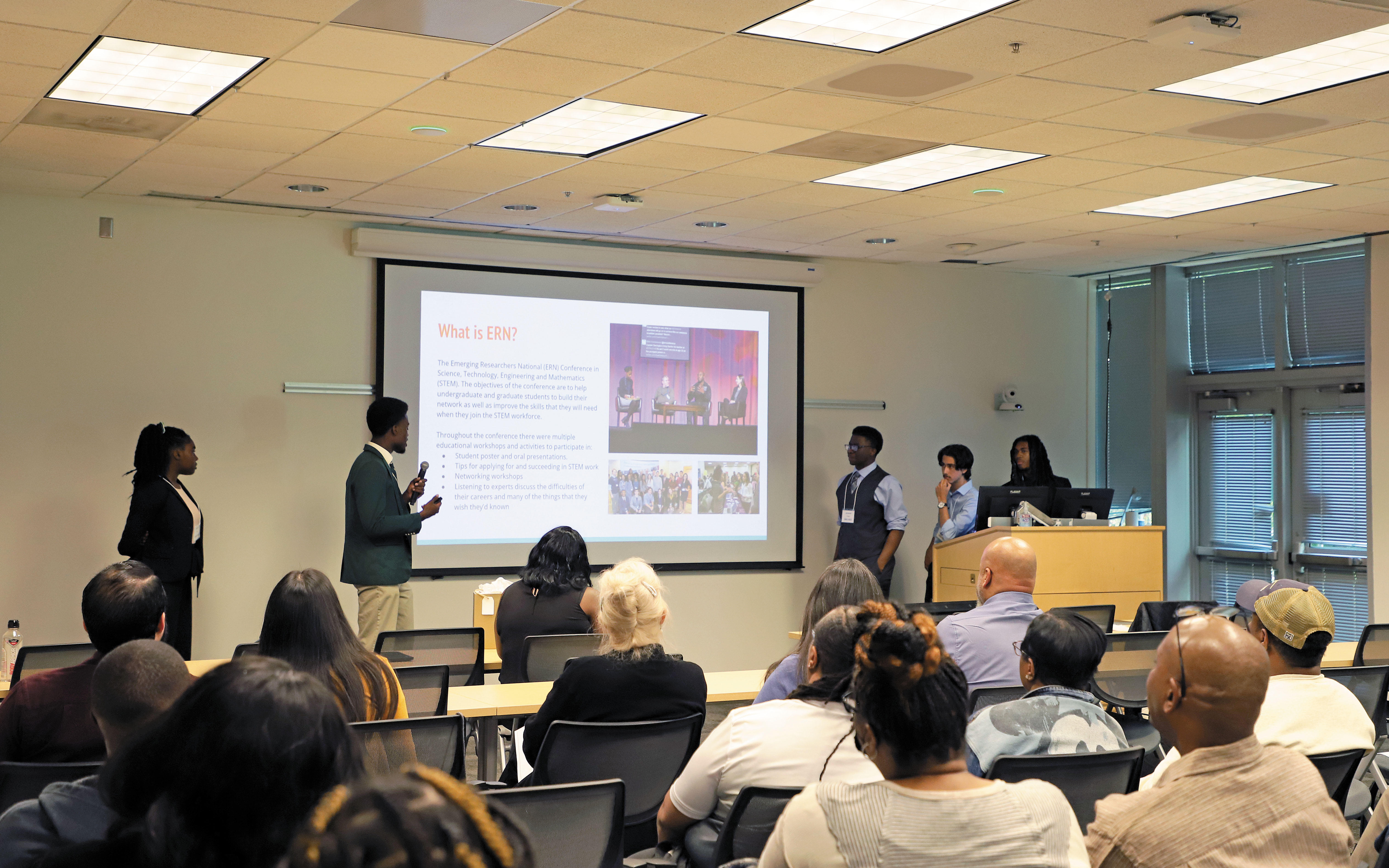 Group of young people giving a presentation to a class
