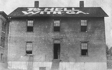 Old rundown building with THWg painted on the Roof