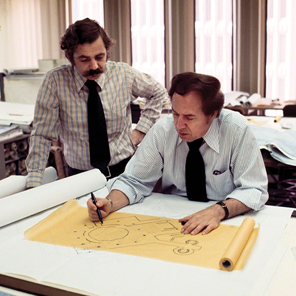 John Portman with another man looking over a drawing