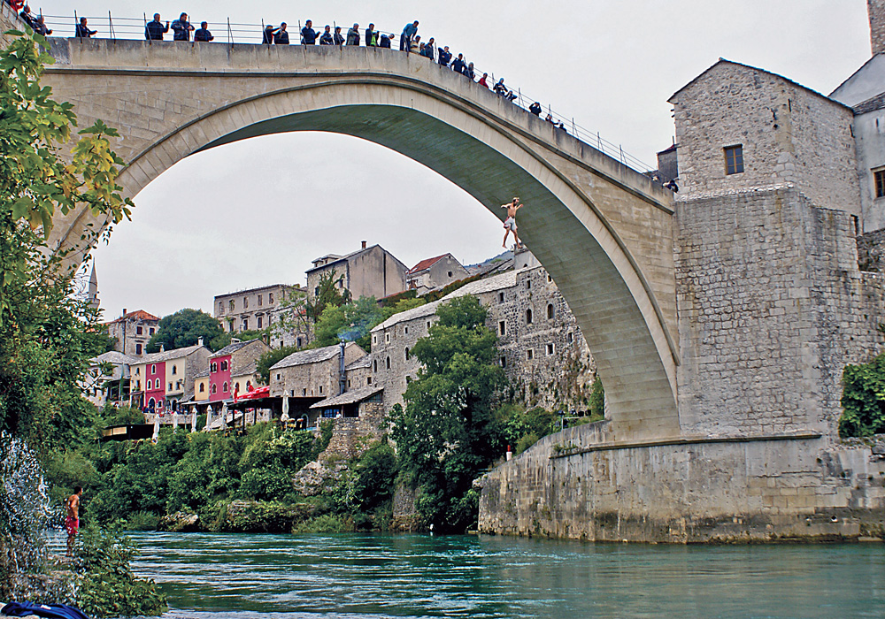Brandon Cox jumping off a bridge into the waters below