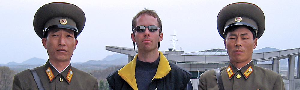 Brandon Cox with two North Korean security officials
