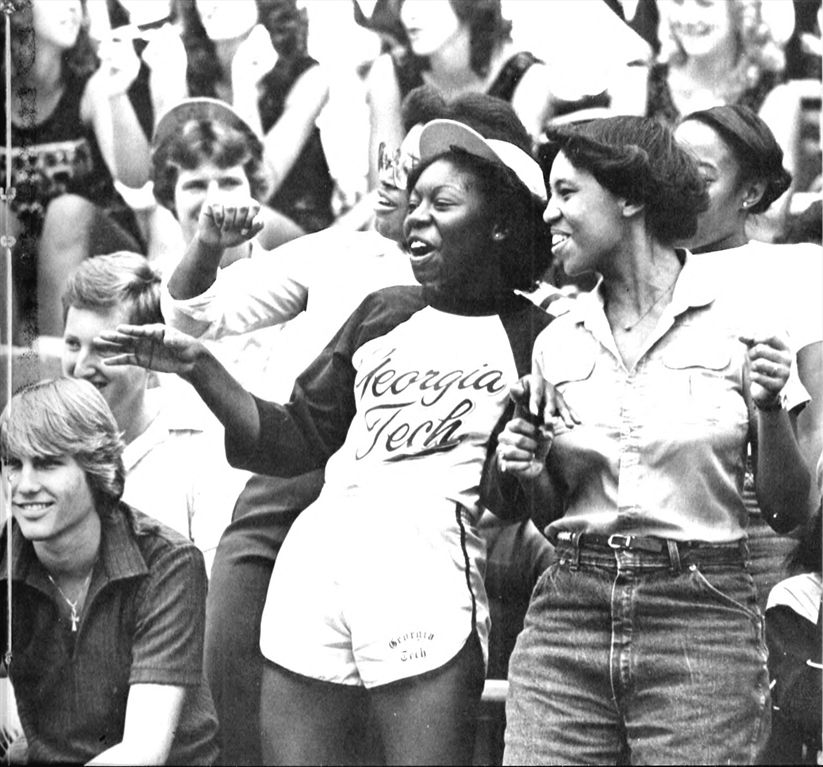 two women laughing in a crowd